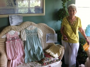 Anna with clothes she made for her grandchildren