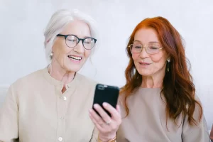 elderly women using phone to video chat to avoid loneliness copy
