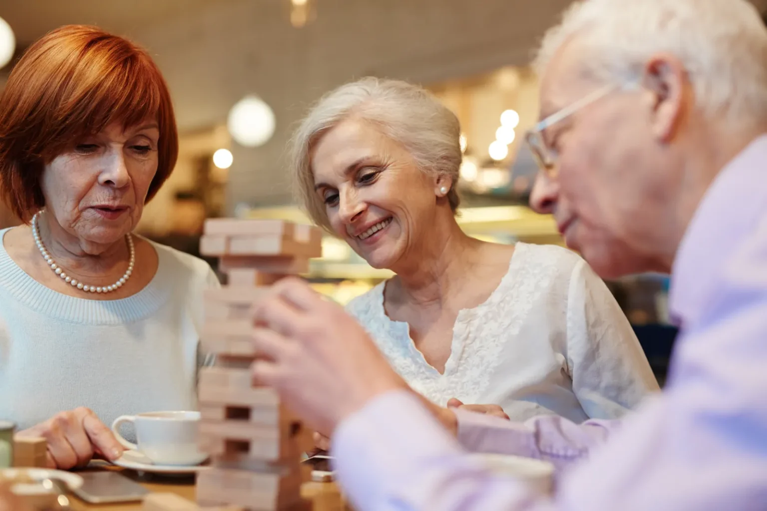 Smiling senior residents socializing together at St. Francis Villa assisted living in River Ridge, LA